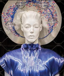 A mannequin wears a blue dress, which is color-enhanced by Philips LED flavors | Shop window display lights
